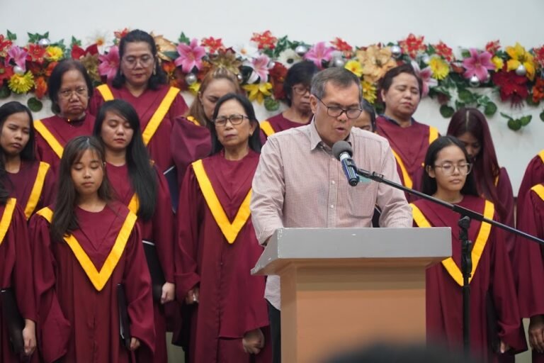 A preacher at the pulpit with the choir behind him